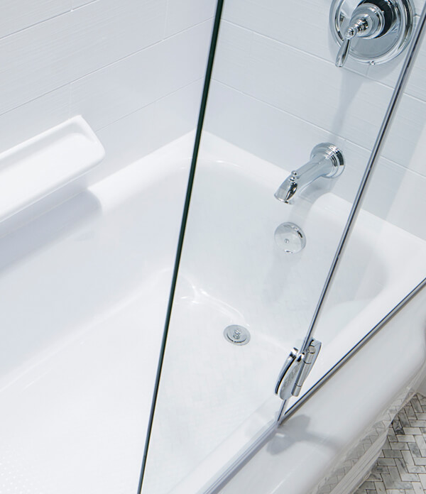 empire bathtub with sliding glass door and chrome faucet