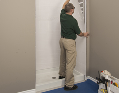 technician installing the shower wall