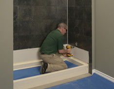 technician fixing the shower wall
